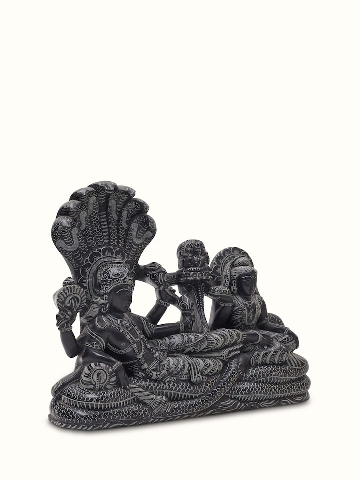 Side view of Carved stone Ananta Sayana idol, showcasing detailed sculpture and craftsmanship.