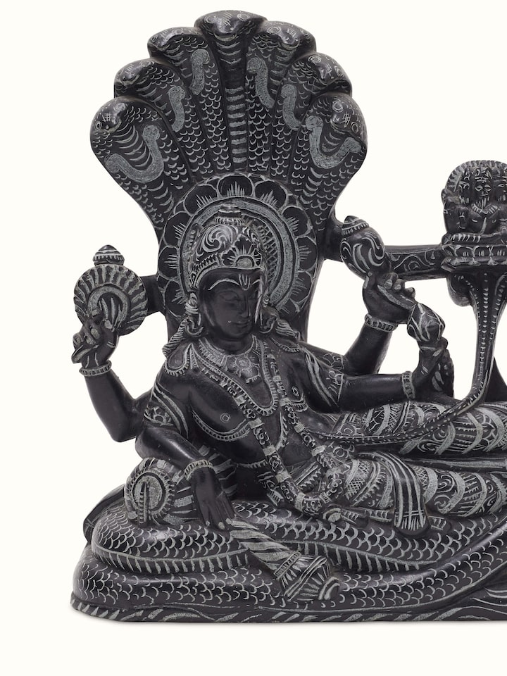Detailed view of Carved stone Ananta Sayana idol, emphasizing texture and intricate carving.