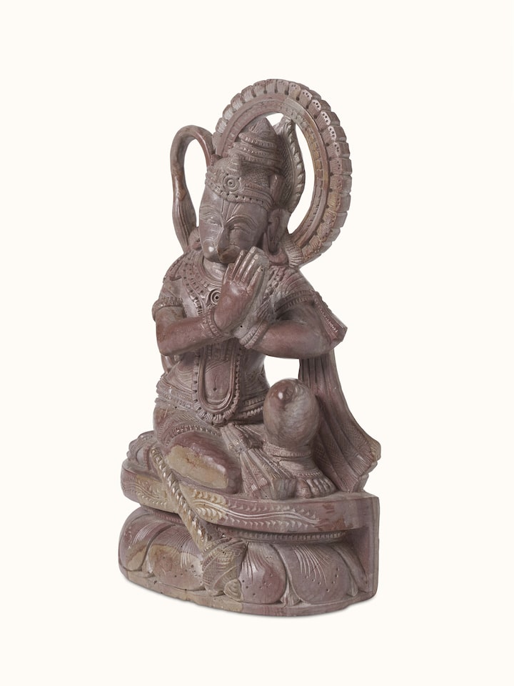 Close-up view of Carved Stone Hanuman Idol, emphasizing the detailed facial features and stone texture