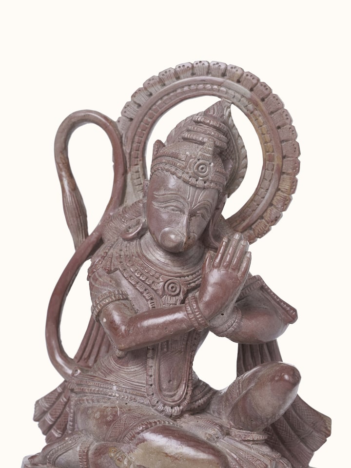 Angled view of Carved Stone Hanuman Idol, showing the three-dimensional quality of the sculpture
