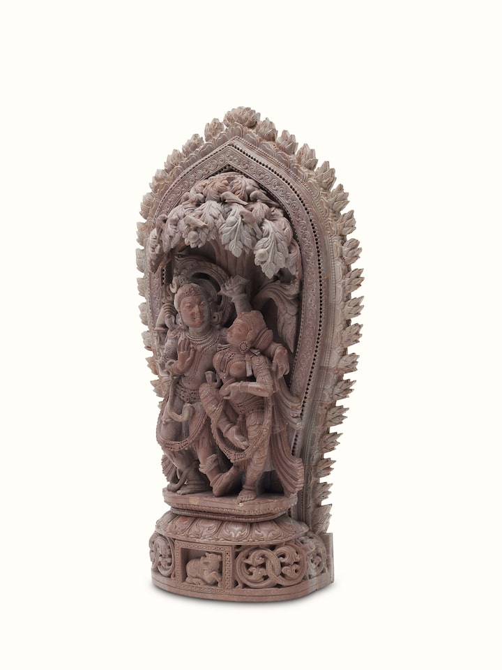 Side view of Carved Stone Dance of Radha & Krishna Idol, highlighting the depth of the carving and the figures’ posture