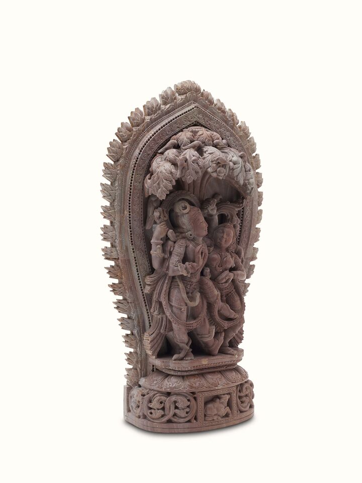 Angled view of Carved Stone Dance of Radha & Krishna Idol, focusing on the dynamic dance pose and stone texture