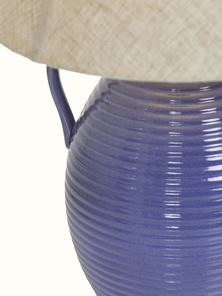 Angled view of the off-white studio pottery & cotton table lamp, displaying its stylish base and shade.