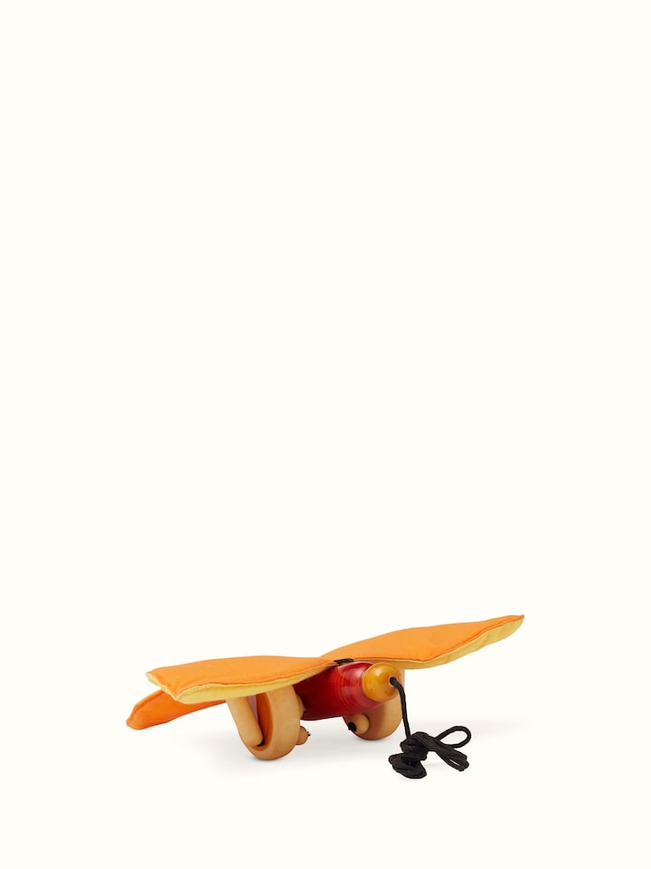 Angled view of Channapatna Wooden Thithli Toy displaying its playful design and artisanal quality