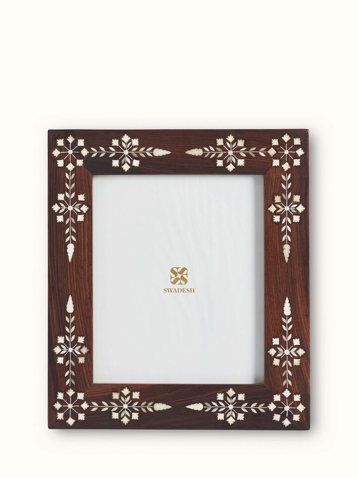 Rectangular Sheesham wood and bone inlaid photo frame with intricate designs and a classic finish.
