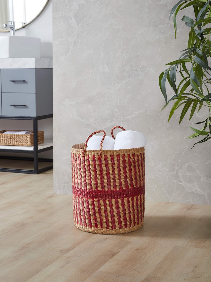Side view of Natural Water Hyacinth Fibre Laundry Basket highlighting the basket's shape and weaving pattern.