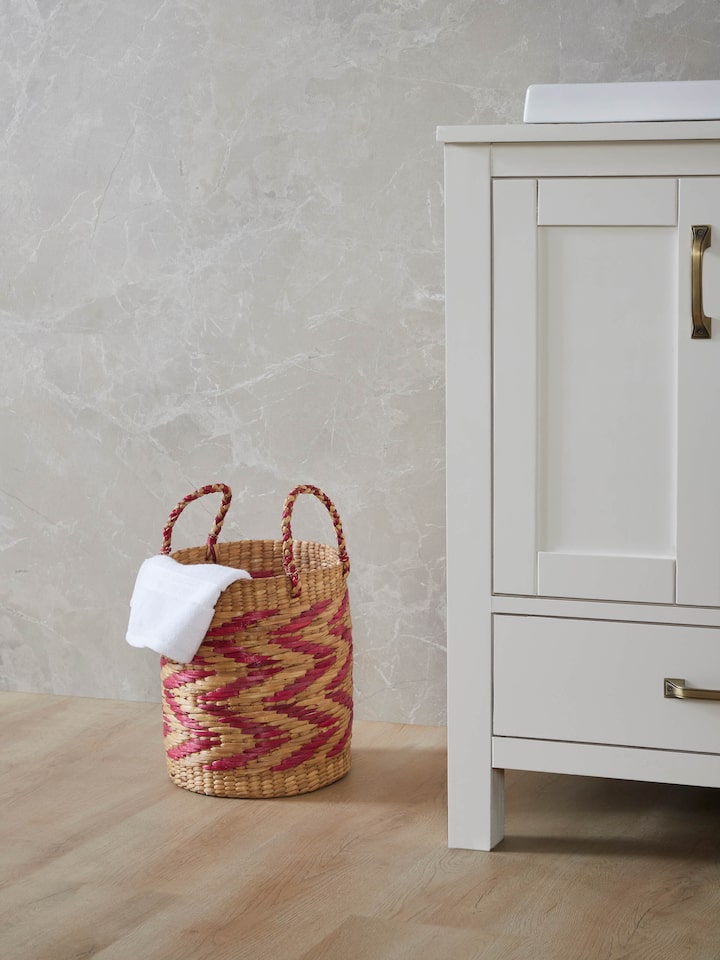Side view of natural water hyacinth fibre waste bin multicolor highlighting the weave pattern