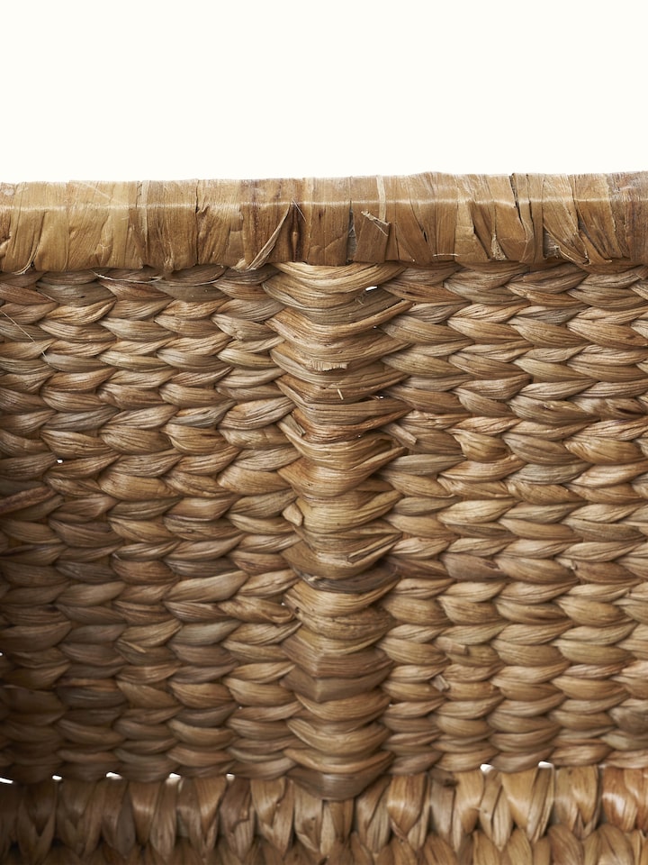 Close-up view of traditional natural water hyacinth fibre storage organiser, highlighting the texture and craftsmanship.