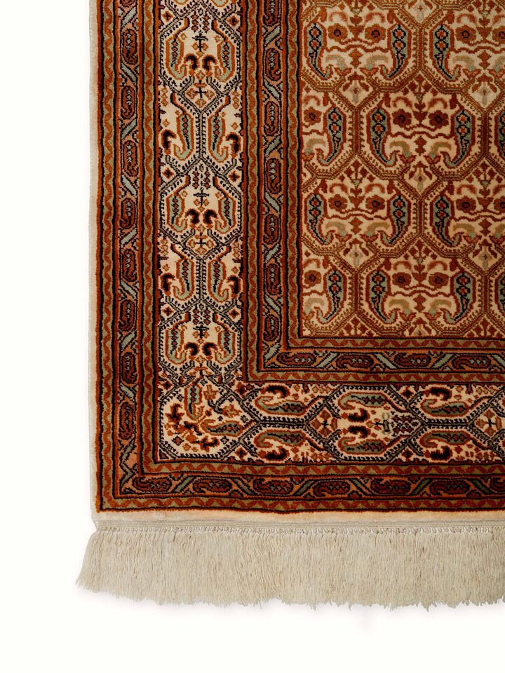 Detailed side view of Traditional Persian Ivory Senna Kashmir Silk Hand-Knotted Carpet showcasing the elegant border and intricate motifs