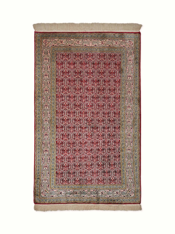 Close-up view of Traditional Persian Red Senna Kashmir Silk Hand-Knotted Carpet highlighting intricate patterns and rich red color.