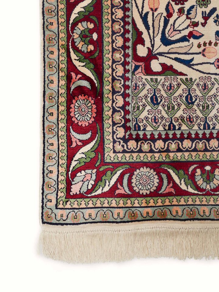 Full view of Traditional Persian Isfahan Kashmir silk hand-knotted carpet displayed in a living space