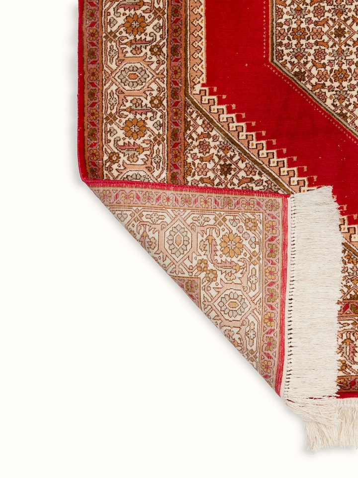 Full view of Traditional Persian Red Senneh Kashmir Silk Hand-Knotted Carpet laid out, showcasing its size and design in a setting.