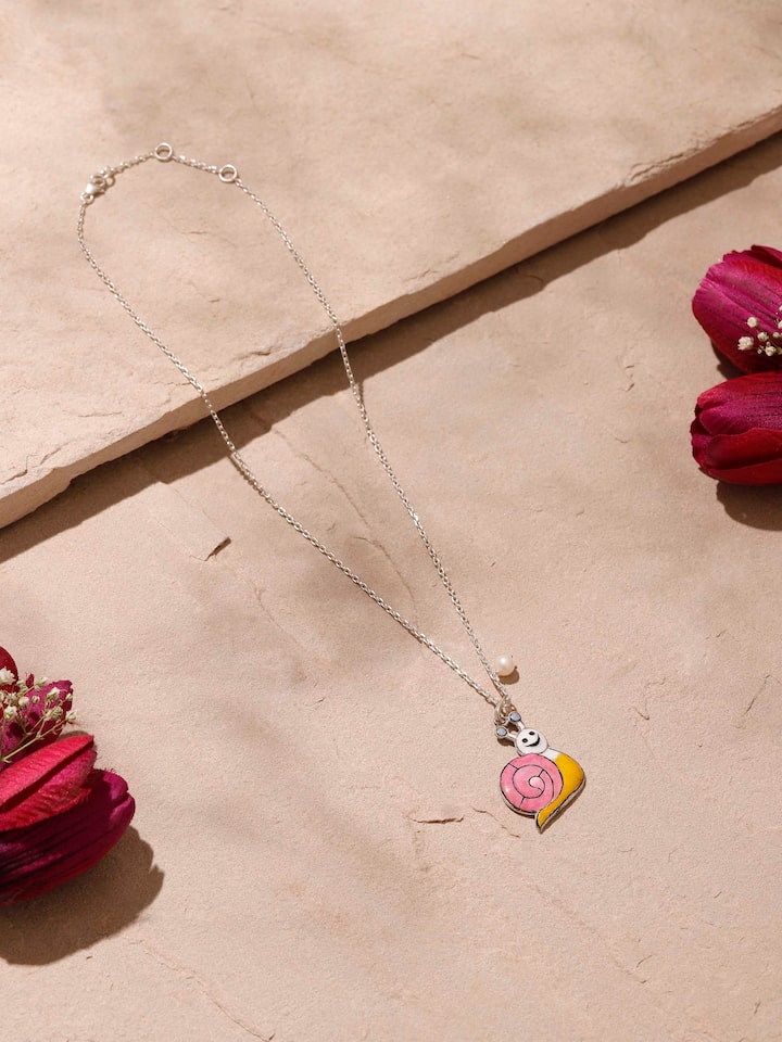 Close-up top view showcasing craftsmanship and pink meenakari work on silver pendant