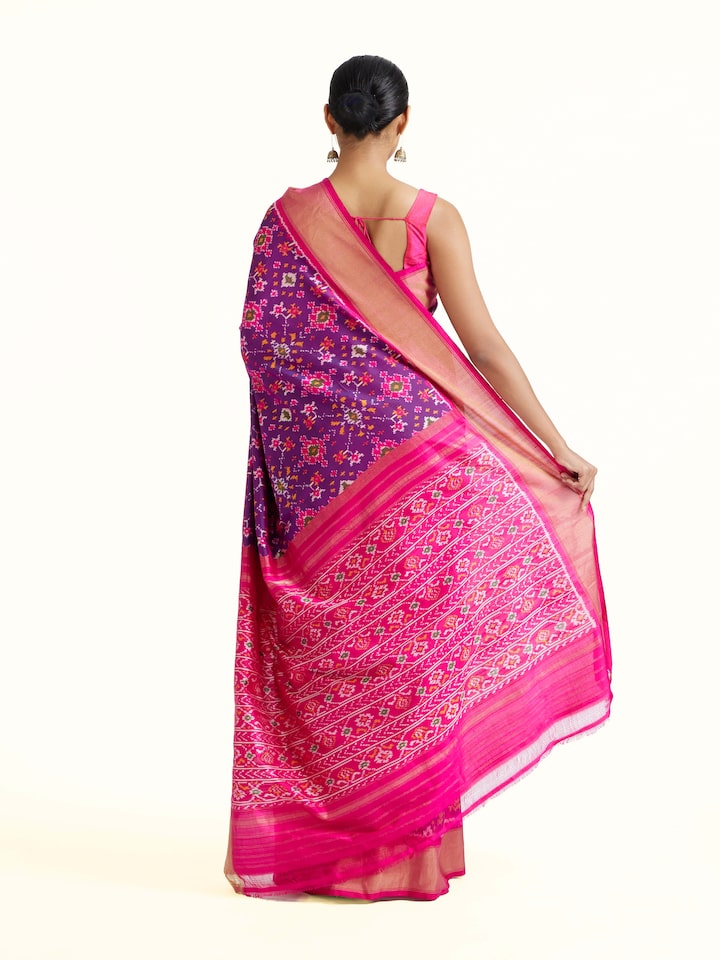 back view of blue weft ikat silk saree with traditional pattern