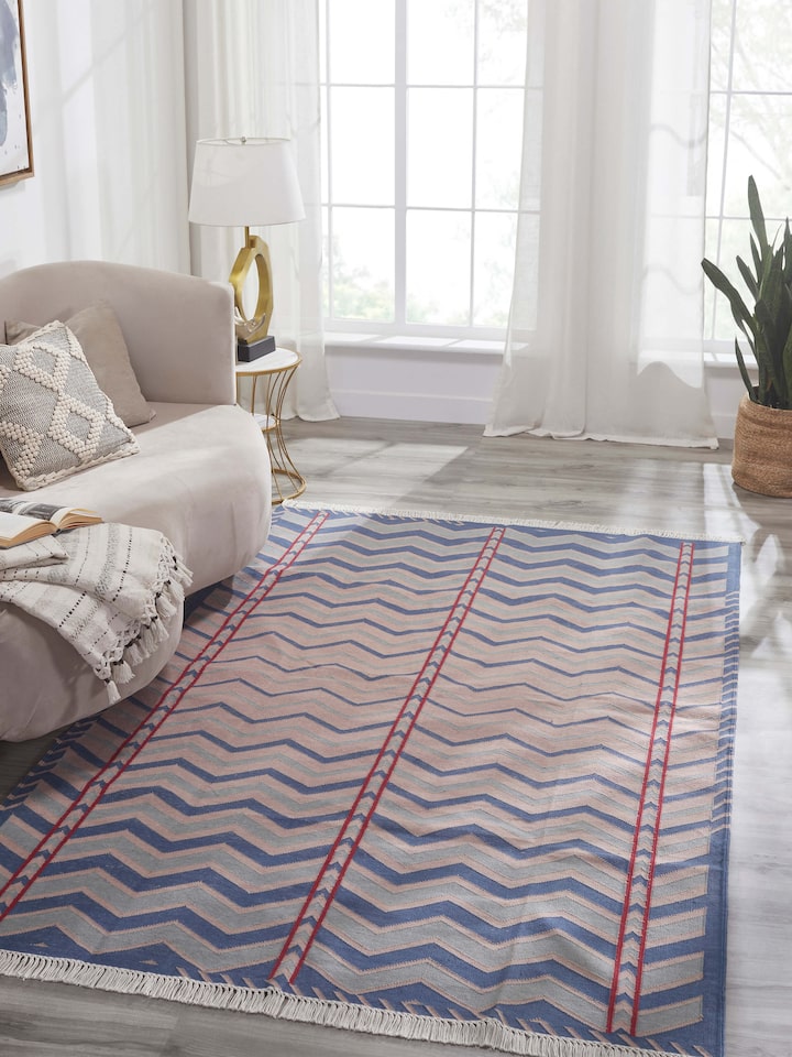 Side view of Geo chevron gradation blue beige lawan cotton panja dhurrie highlighting the fabric texture and pattern.