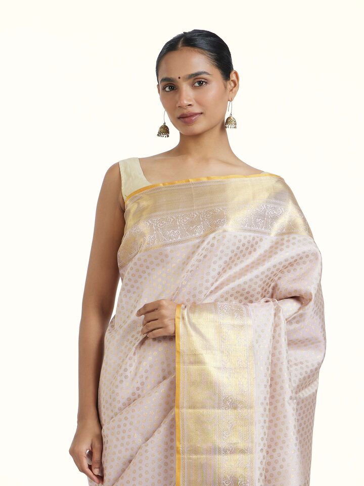 Angled view of Light Pink Kancheepuram Silk Zari Saree revealing the depth of its color and intricate pattern