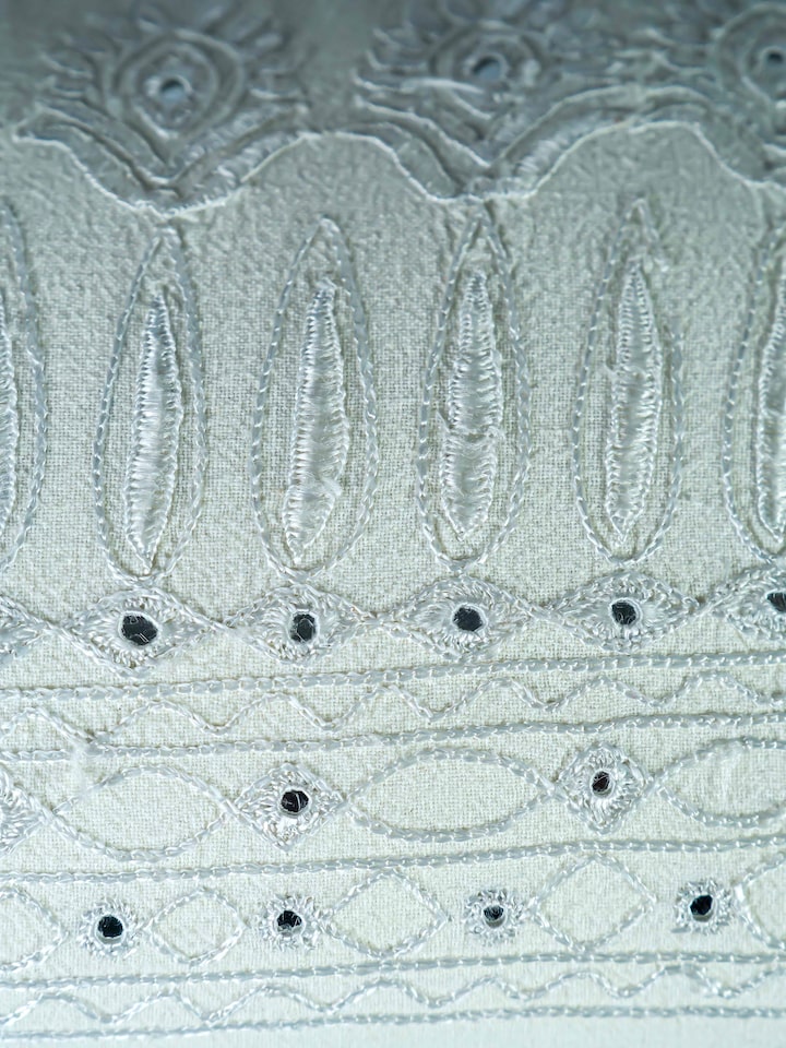 Close-up of the Lippan White Pakko Border Hand Embroidered Cotton Cushion Cover