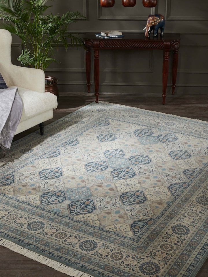 Lifestyle shot of blue-grey Sarouk rug showcasing floral motifs and rich wool texture in a room setting
