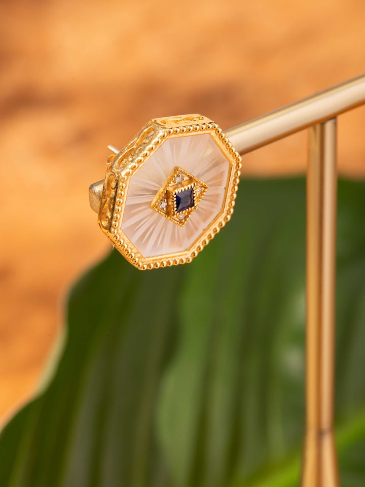 Styled detail view of Lapidary 14 Karat Gold Studs displayed, shown in another styled shot