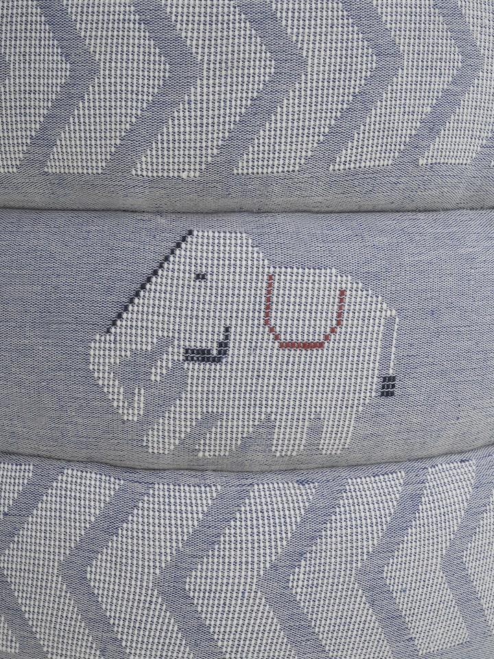 Detailed view of the pouffe’s fabric pattern and the quality of the Sheesham wood, emphasizing the fine finish and design