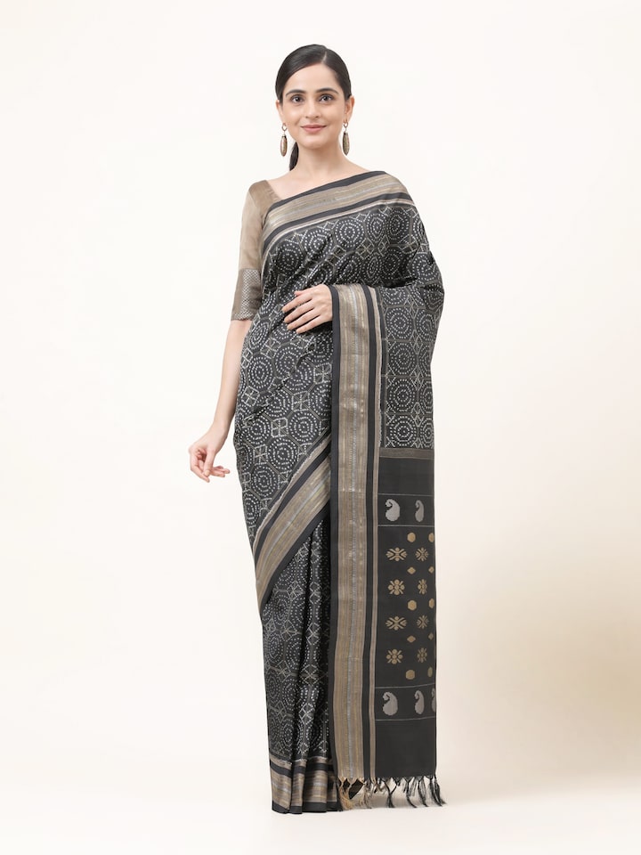 Front view of black silk double Ikat saree with symmetrical geometric patterns and lustrous finish