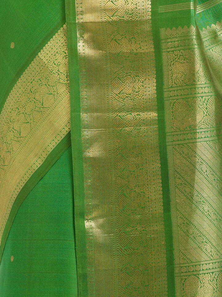 Detail view of green silk Kancheepuram saree showing silk texture and zari work