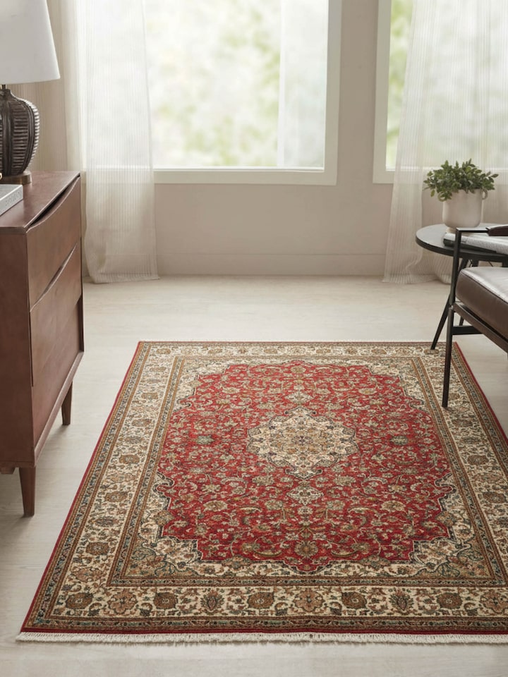 Traditional Kashan red Kashmir silk hand-knotted carpet with intricate floral design, lifestyle view