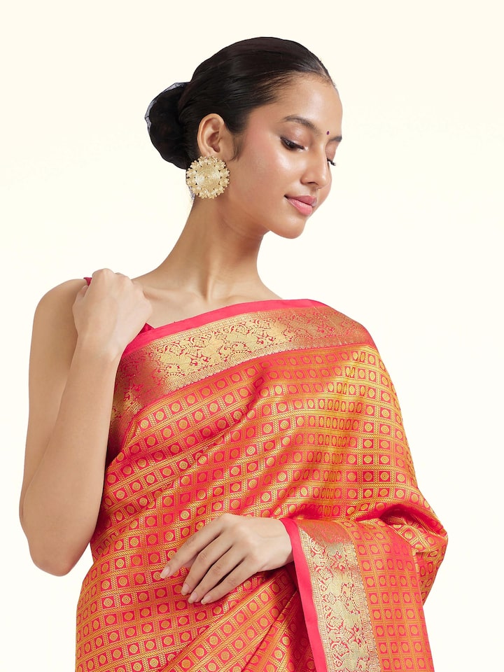 Angled view of gold silk Kancheepuram saree highlighting classic weave and radiant sheen
