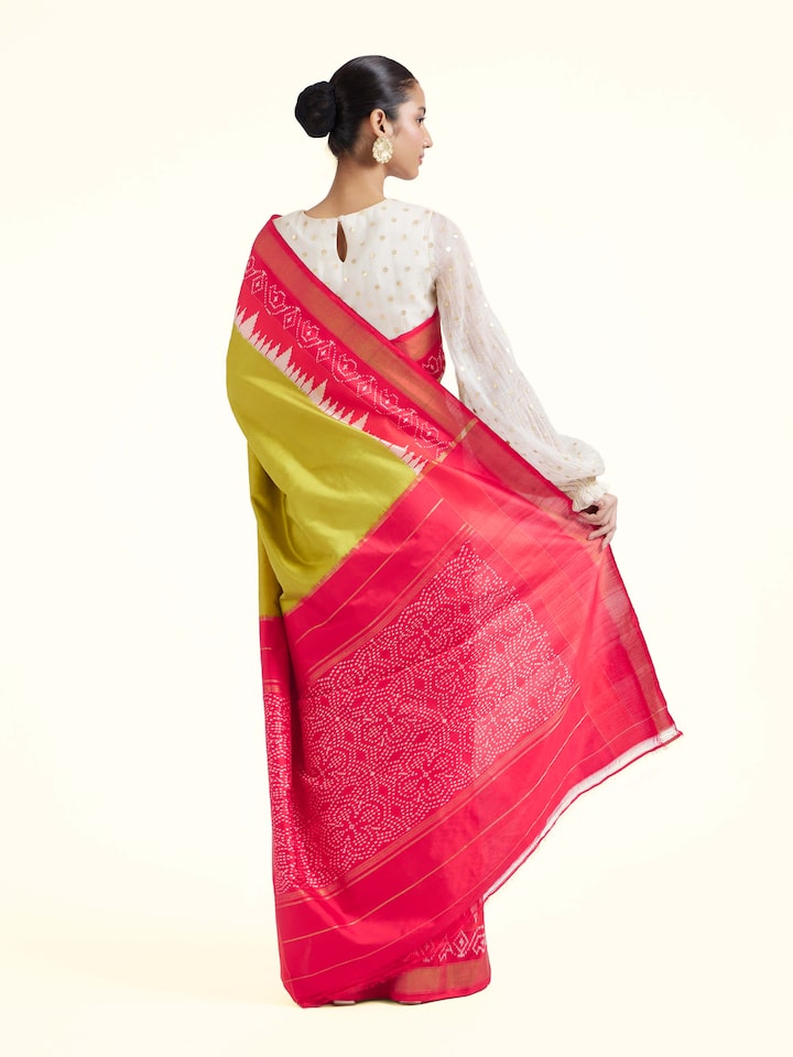 Back view of mustard mulberry silk ikat saree displaying pallu design