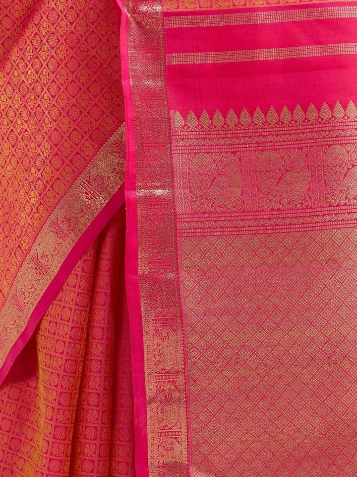 Detail view of orange silk Kancheepuram saree showing silk texture and zari craftsmanship