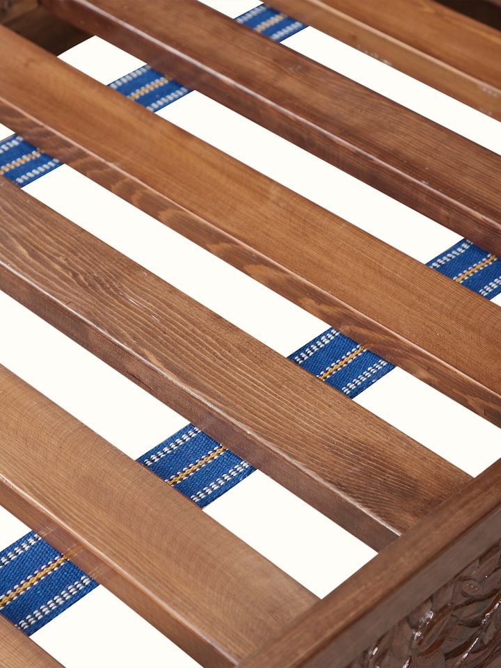 Detail view of Carved Walnut Wood Queen-size Bed showing the wooden slat base