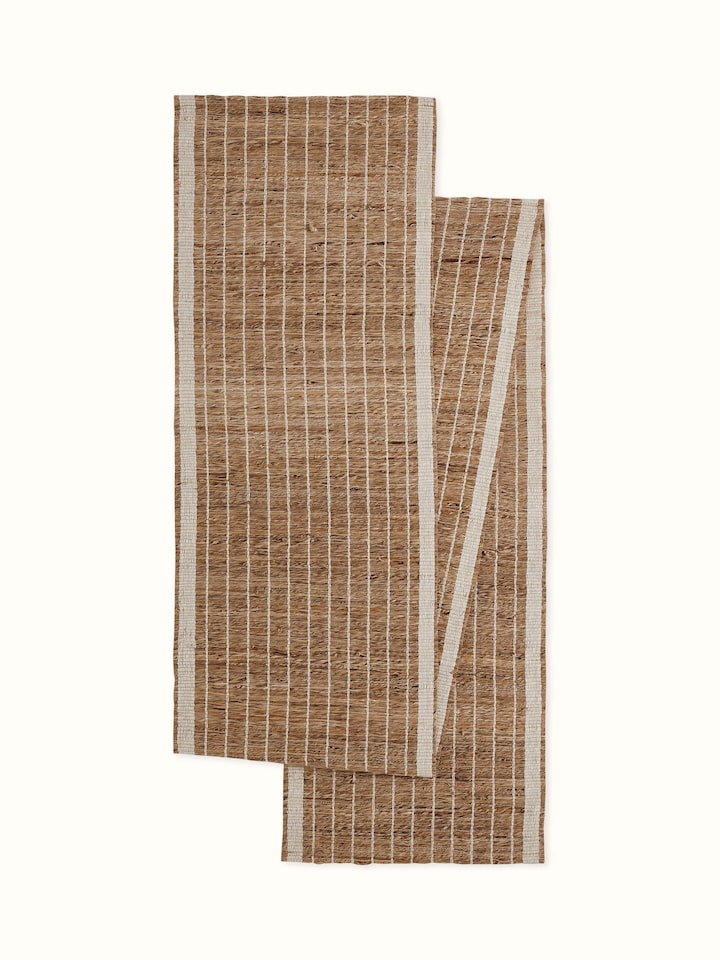 Front view showing the off-white striped pattern woven from natural banana fibers, designed for a 6-seater table