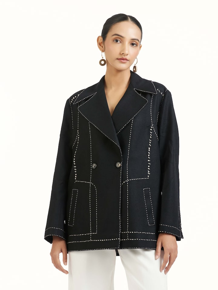 Angled view of black wool kantha jacket highlighting kantha stitch work