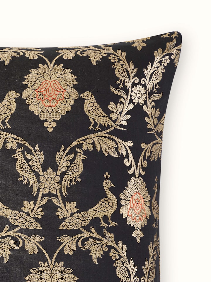 Detail side view of fabric texture on black Jaal Banarasi cushion cover