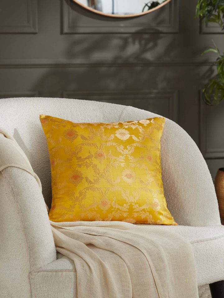 Lifestyle view of Awadh Yellow Jaal Banarasi Silk Cushion Cover, highlighting its elegant jaal design in a home setting.