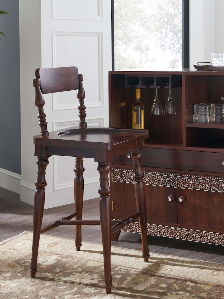 Side view of Sheesham wood bar stool from Swadesh showcasing its sturdy wooden structure and sleek design for modern spaces.