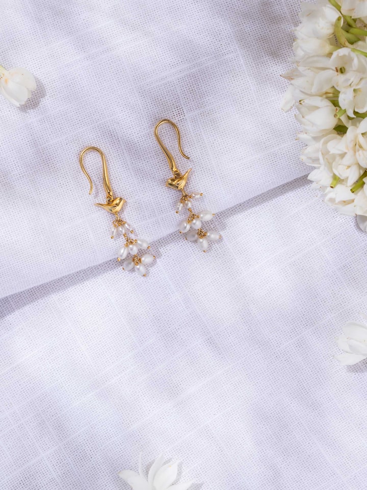 lifestyle view of silver smithing drop earrings