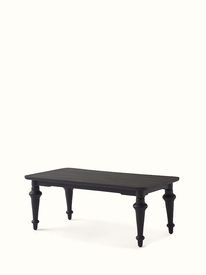 Side view of the Sheesham wood coffee table, emphasizing its sleek design and brass inlay details