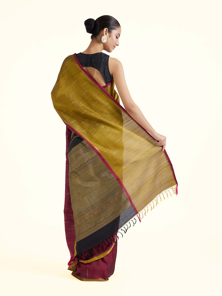 Back view of brown silk Kancheepuram saree displaying ornate pallu design