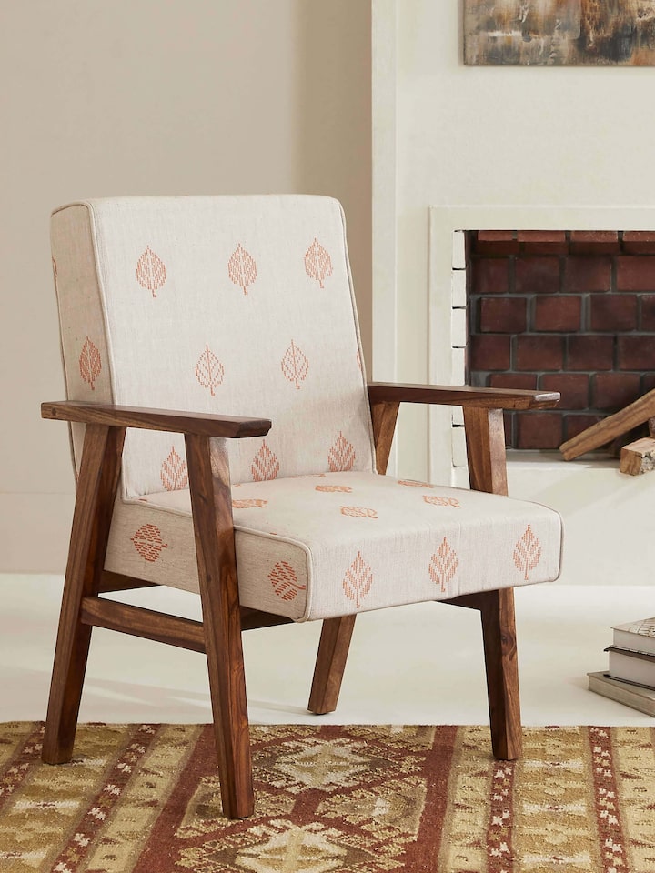 Side view of Bawan Buti Upholstered Sheesham Wood Study Chair showcasing intricate carvings and plush upholstery.