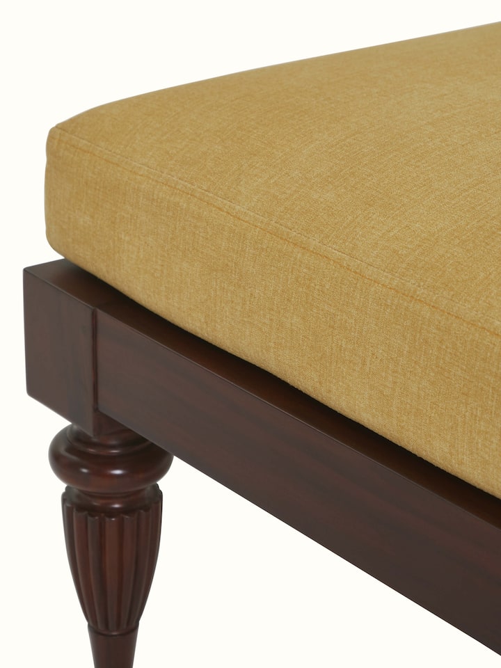 Detailed side view of Upholstered Mahogany Wood Ottoman by Swadesh showcasing its sturdy legs and smooth finish.