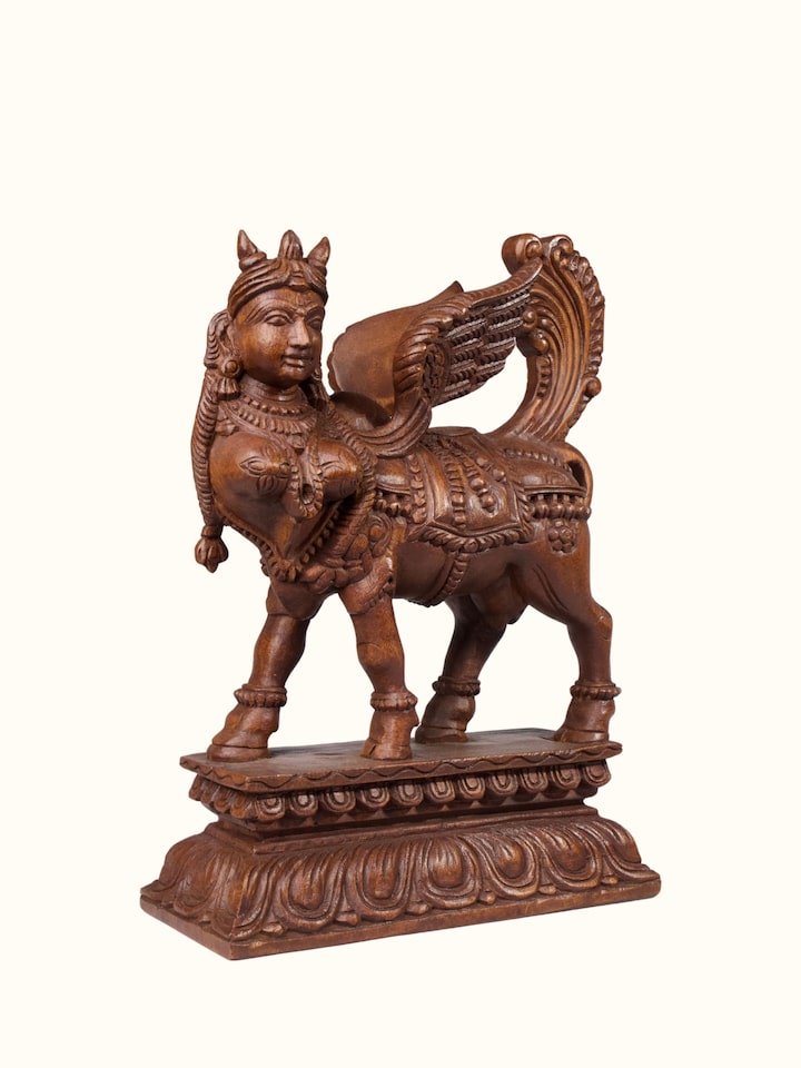 Angled view of the Wood Carved Kamadhenu Idol