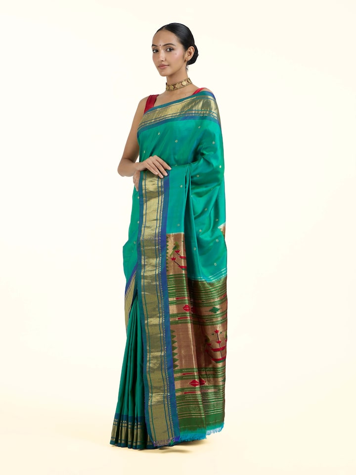 Side view of green silk Paithani saree highlighting lustrous drape and contrast border