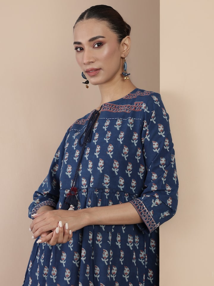 Side lifestyle view highlighting silhouette and block print of blue cotton A-line midi dress