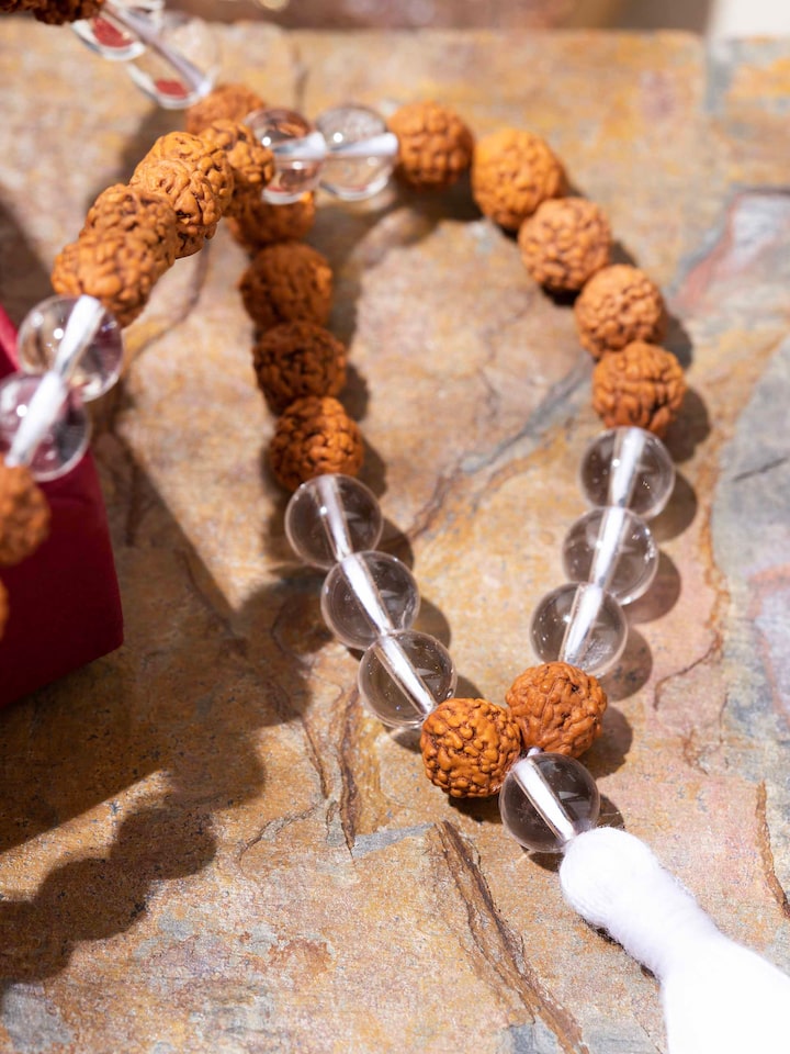 Angled view of Rudraksha & Sphatik Mala showcasing reflective Sphatik stones and symbolic balance