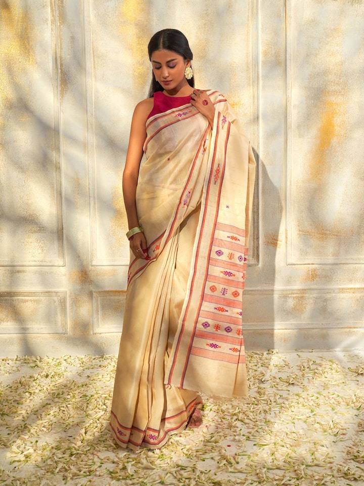 Side view of off-white Tussar silk saree highlighting elegant drape and raw silk appeal