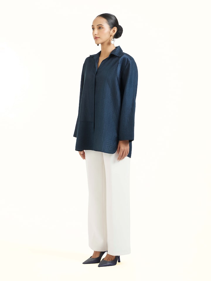 Side view of blue silk kantha shirt highlighting relaxed silhouette