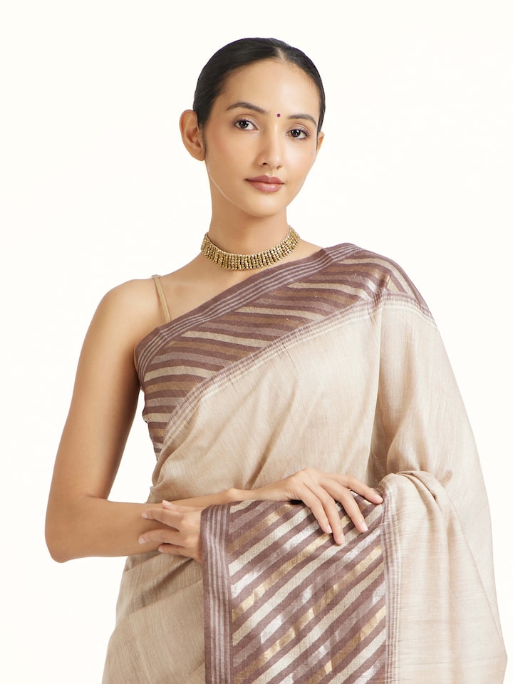 Angled view of the Beige Tussar Muga Silk Saree
