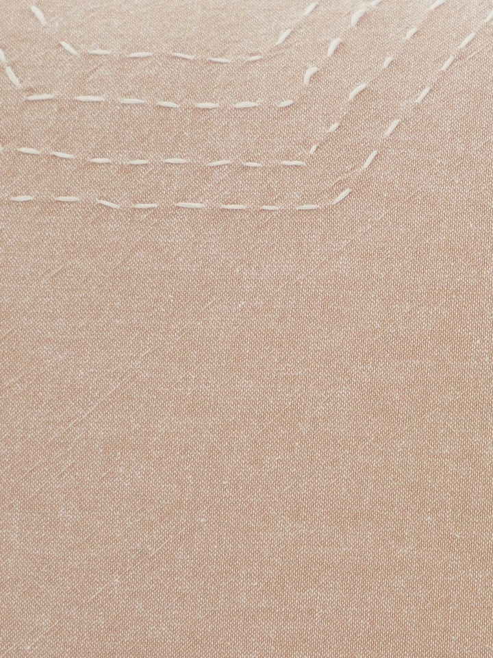 Side detail view of Kahani Brown Cotton Pillow Shams showcasing textured stitching and traditional craftsmanship