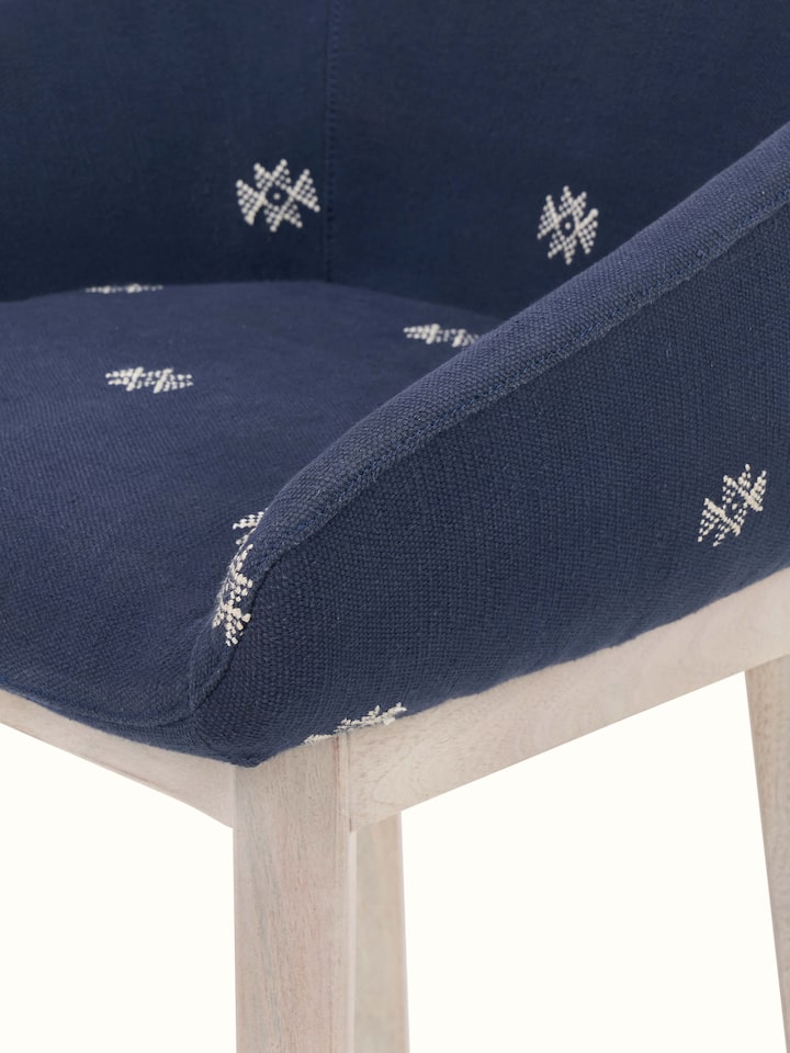 Side view displaying the comfortable upholstery and sturdy acacia wood base.